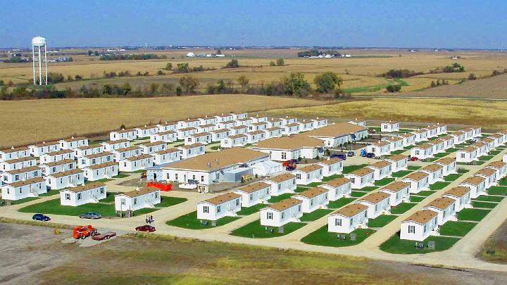 5MVC Aerial.jpg - These are the first 100 homes for the Maharishi Vedic Pandits in Maharishi Vedic City, Iowa, USA. Each home is 76 feet (23 metres) long, and 32 feet (9.5 metres) wide. The three large buildings in the middle are for group practice of Transcendental Meditation and the TM Sidhi Programme including Yogic Flying; dining hall and kitchen; and Mandap Hall for Maharishi Yagya performances.